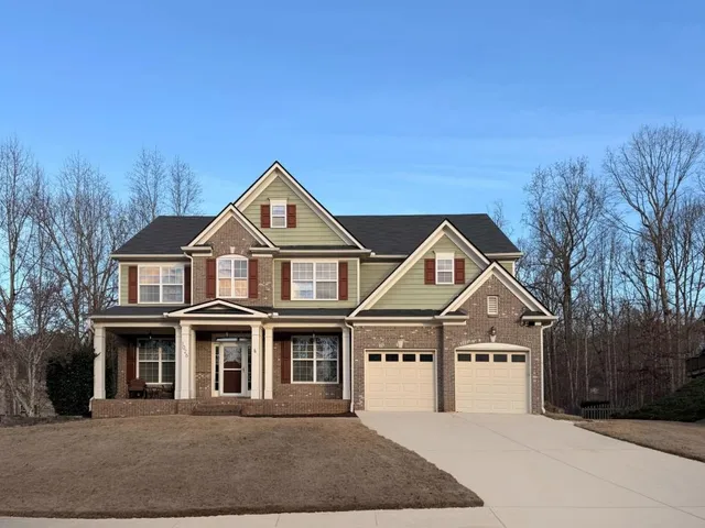 a front view of a house with a yard and garage