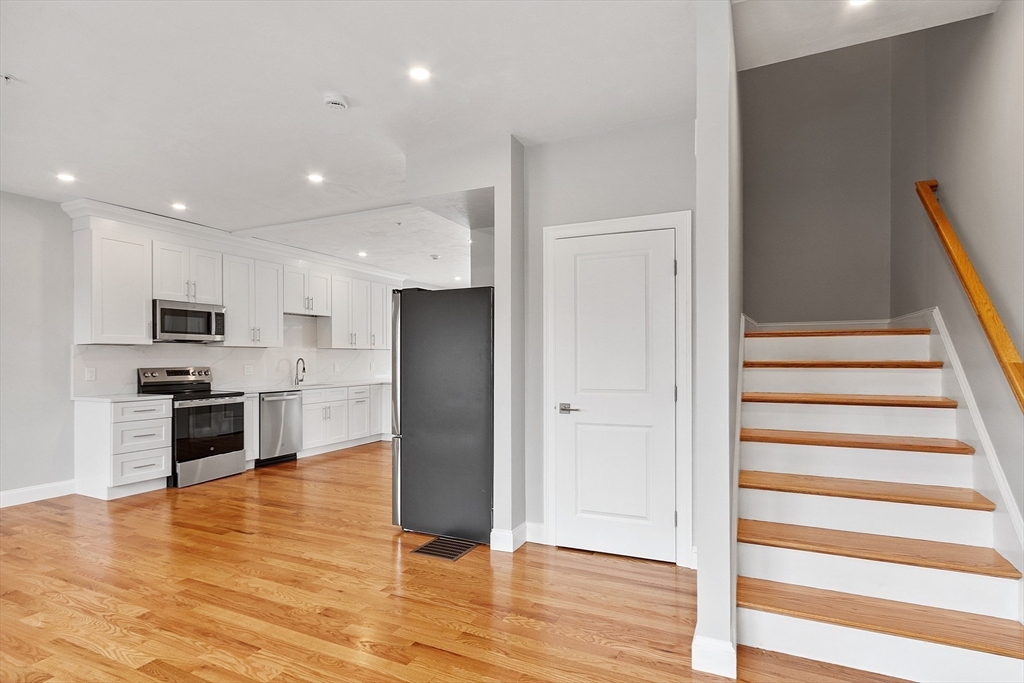 10 Windsor Street Worcester, MA 01605 - Photo 8 of 26 a kitchen with stainless steel appliances refrigerator and microwave