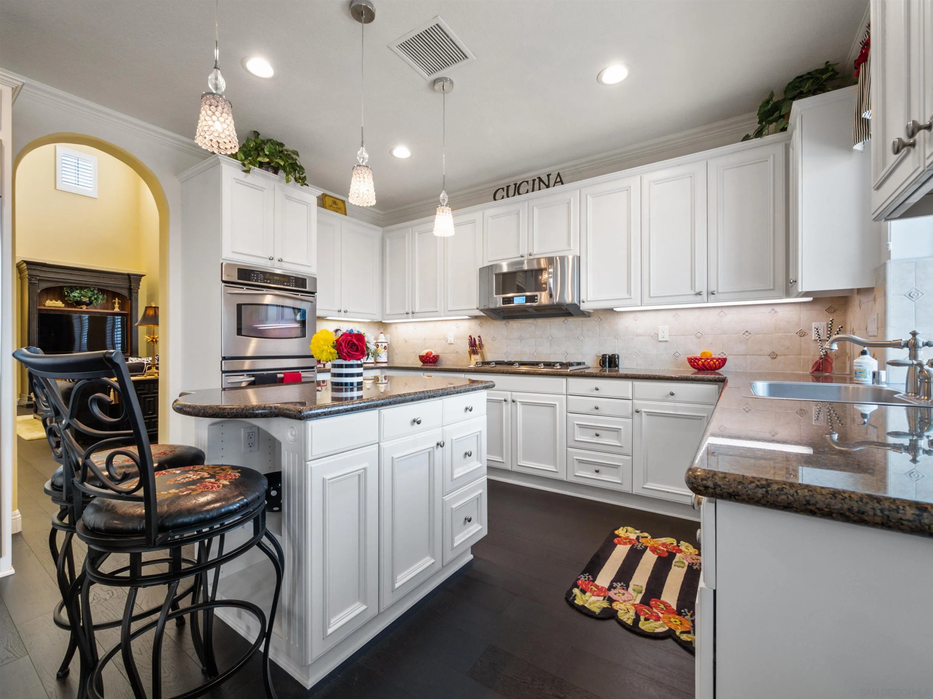 27751 Country Lane Road Laguna Niguel, CA 92677 - Photo 23 of 43 a kitchen with stainless steel appliances granite countertop a sink dishwasher a stove and white cabinets with wooden floor
