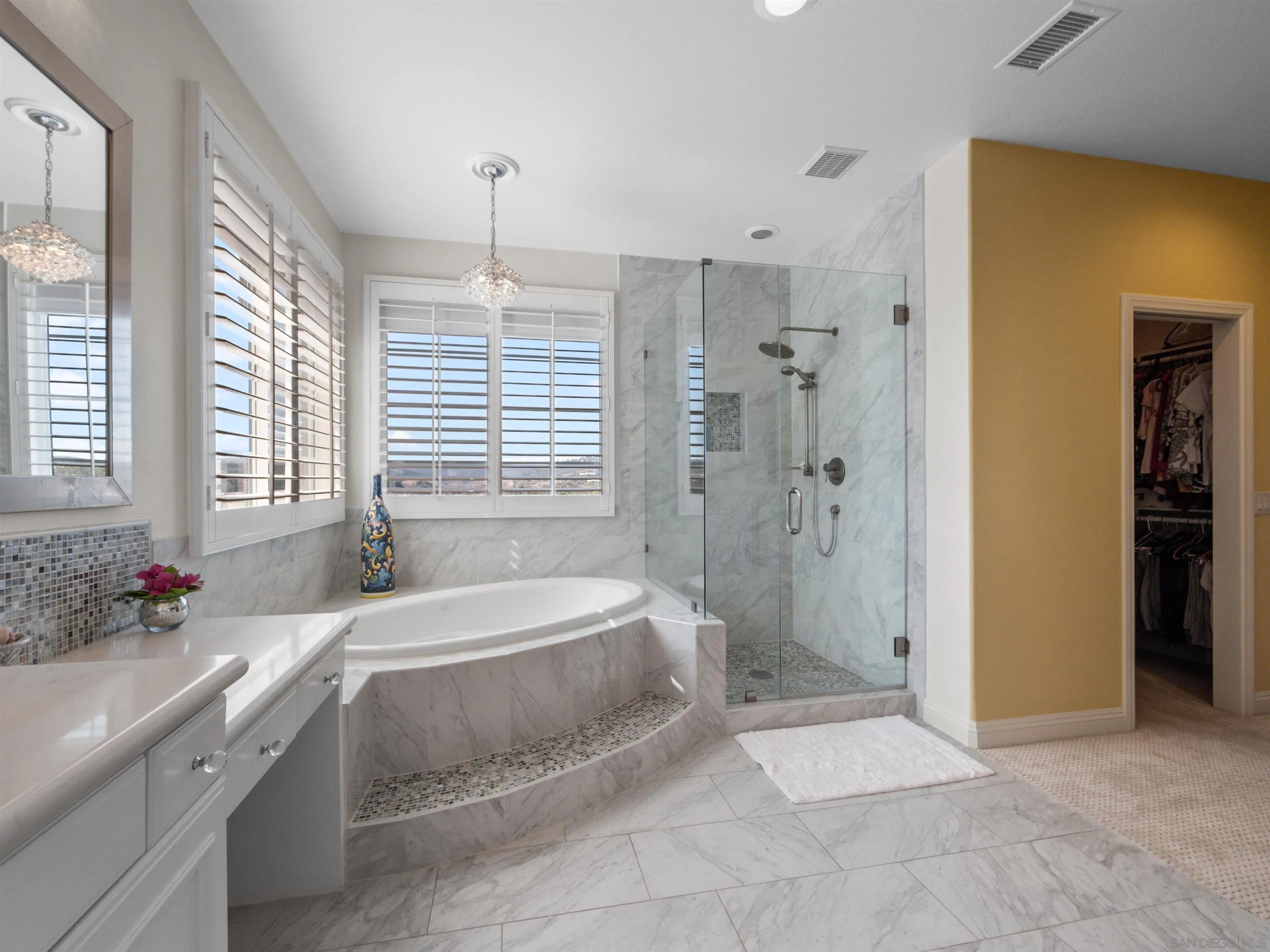 27751 Country Lane Road Laguna Niguel, CA 92677 - Photo 40 of 43 a spacious bedroom with a bed and a chandelier