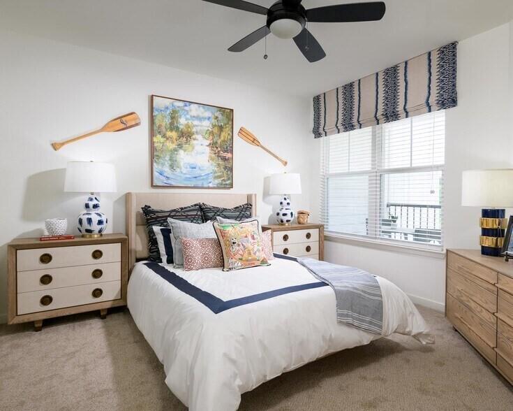 6255 Riverview Road Southeast, Unit B1 Smyrna, GA 30126 - Photo 14 of 17 a spacious bedroom with a bed a dresser next to a window