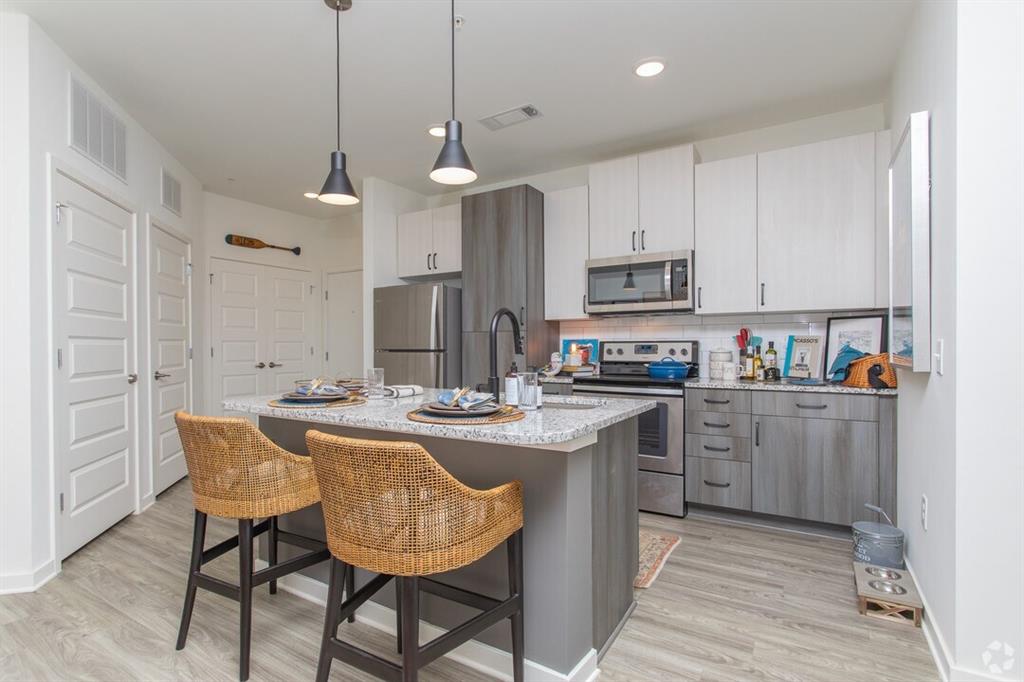 6255 Riverview Road Southeast, Unit B1 Smyrna, GA 30126 - Photo 10 of 17 a kitchen with kitchen island granite countertop a sink a center island and appliances