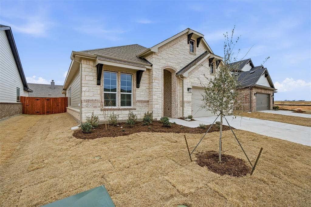 1228 Sabine River Lane Springtown, TX 76082 - Photo 4 of 30 View of front of home featuring stone siding, driveway, a gate, and a shingled roof