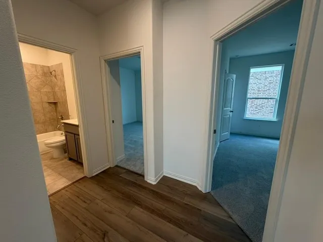 a view of a bathroom from a hallway