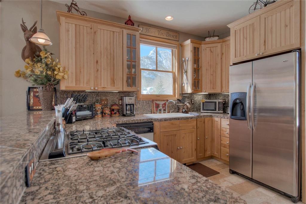 334 D Streamside Lane Frisco, CO 80443 - Photo 13 of 35 a kitchen with stainless steel appliances granite countertop a refrigerator sink and cabinets