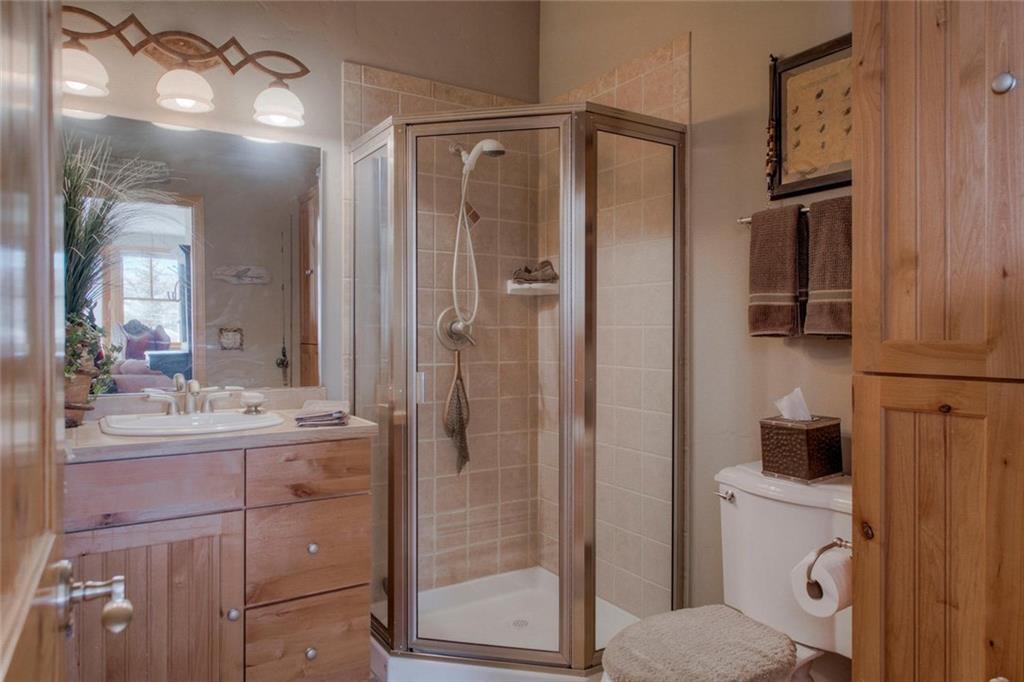334 D Streamside Lane Frisco, CO 80443 - Photo 14 of 35 a bathroom with a shower sink and mirror