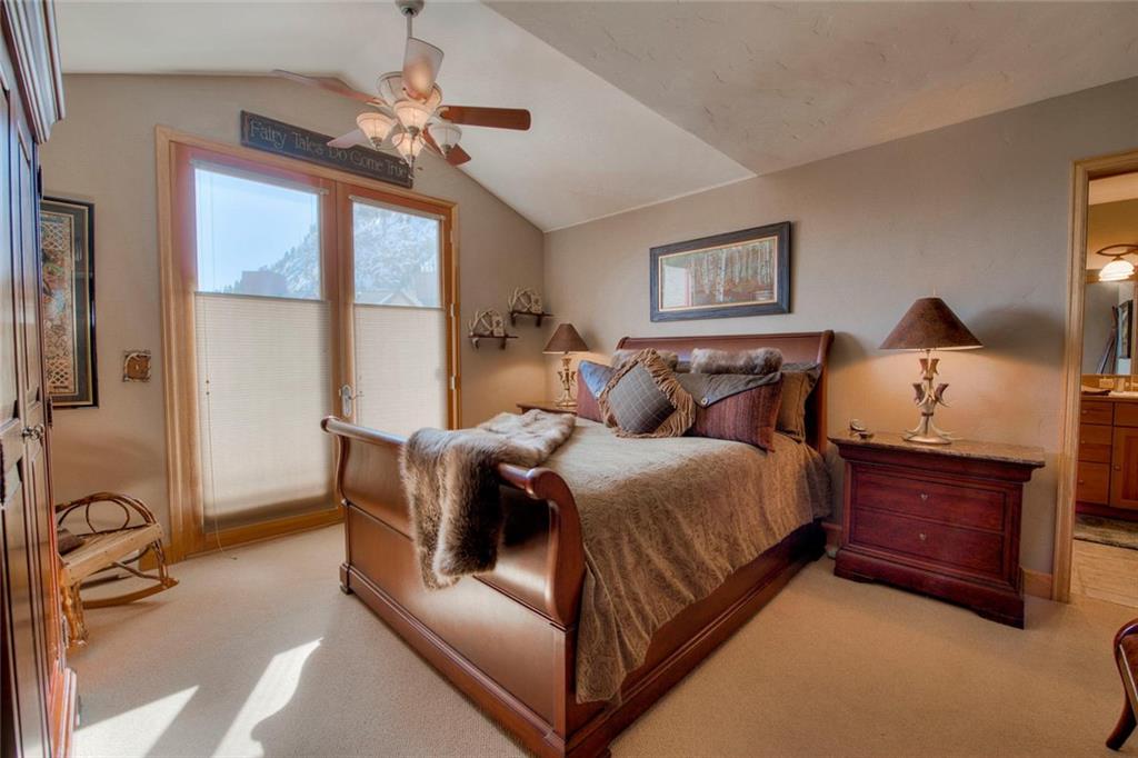 334 D Streamside Lane Frisco, CO 80443 - Photo 18 of 35 a spacious bedroom with a bed and window