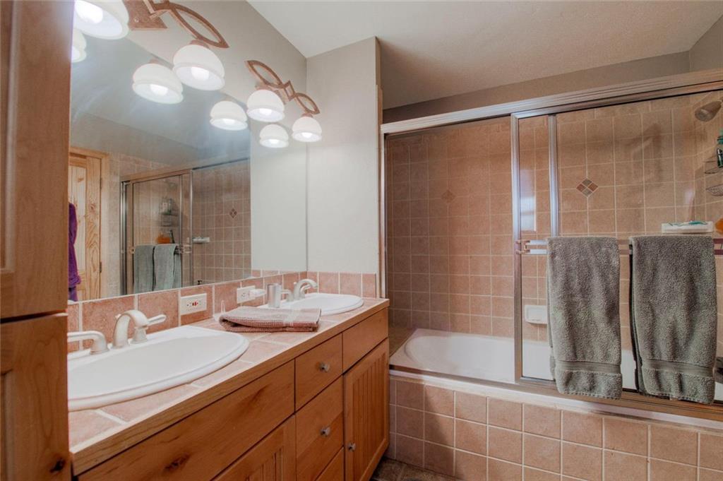 334 D Streamside Lane Frisco, CO 80443 - Photo 20 of 35 a bathroom with a double vanity sink mirror and shower