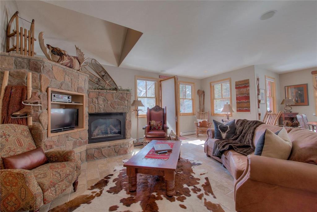334 D Streamside Lane Frisco, CO 80443 - Photo 3 of 35 a living room with furniture a flat screen tv and a fireplace