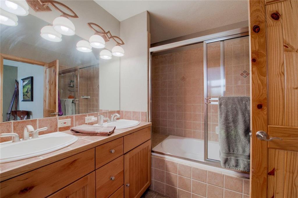 334 D Streamside Lane Frisco, CO 80443 - Photo 21 of 35 a bathroom with a double vanity sink and a mirror