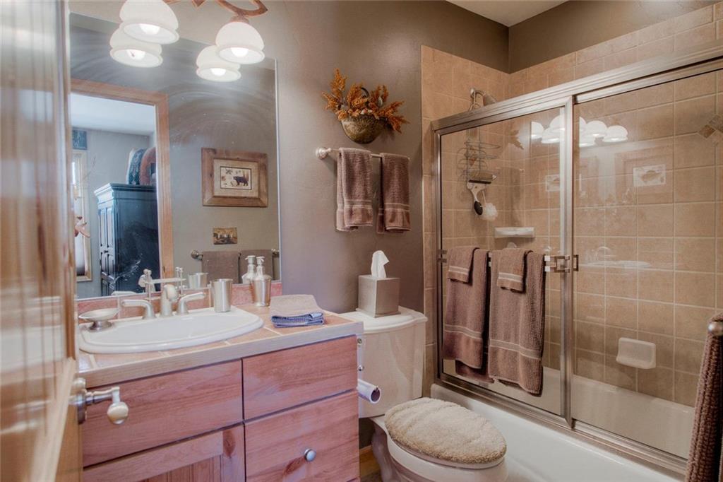 334 D Streamside Lane Frisco, CO 80443 - Photo 26 of 35 a bathroom with a sink a toilet a mirror and shower