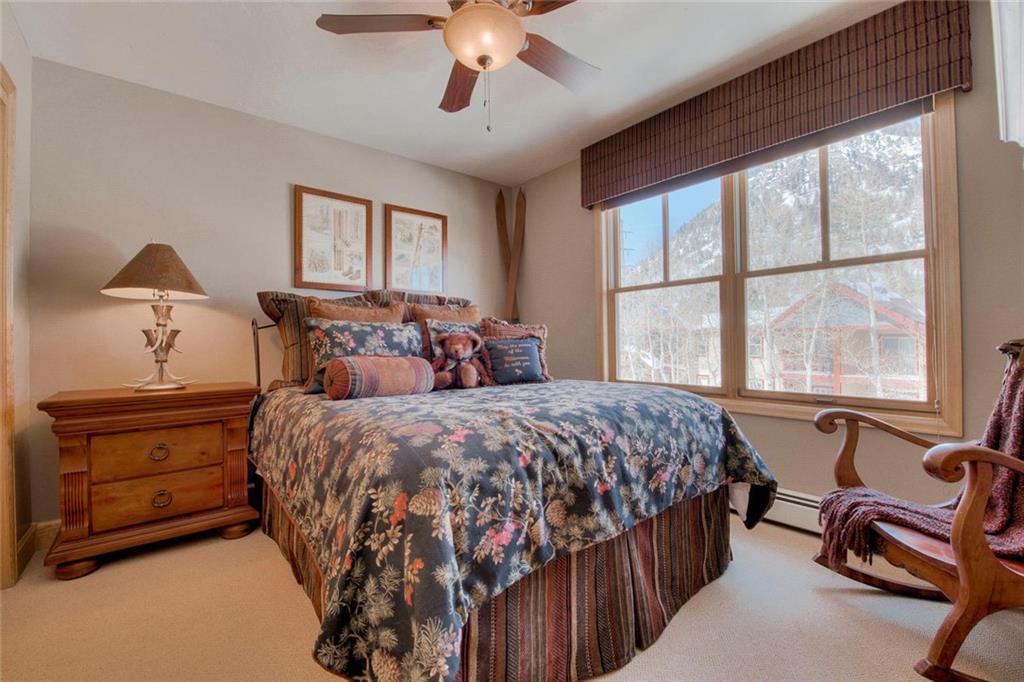 334 D Streamside Lane Frisco, CO 80443 - Photo 29 of 35 a bedroom with a bed and a chandelier