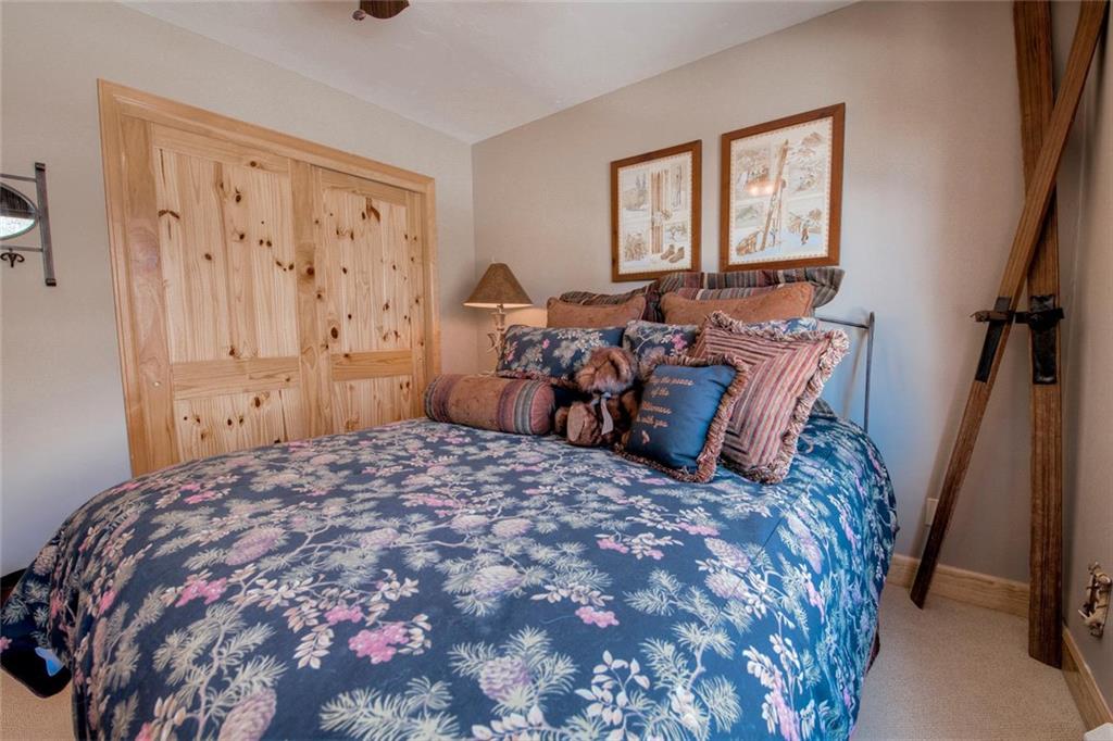 334 D Streamside Lane Frisco, CO 80443 - Photo 30 of 35 a bed sitting in a bedroom next to a window