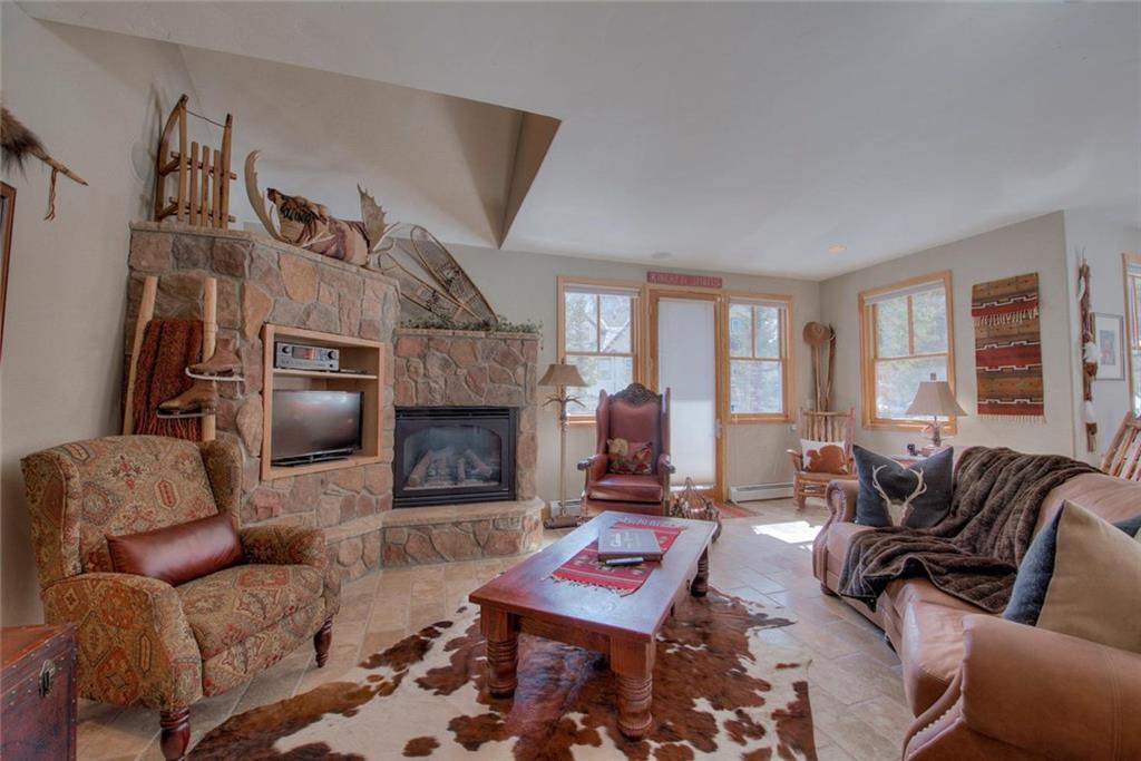 334 D Streamside Lane Frisco, CO 80443 - Photo 5 of 35 a living room with furniture a flat screen tv and a fireplace