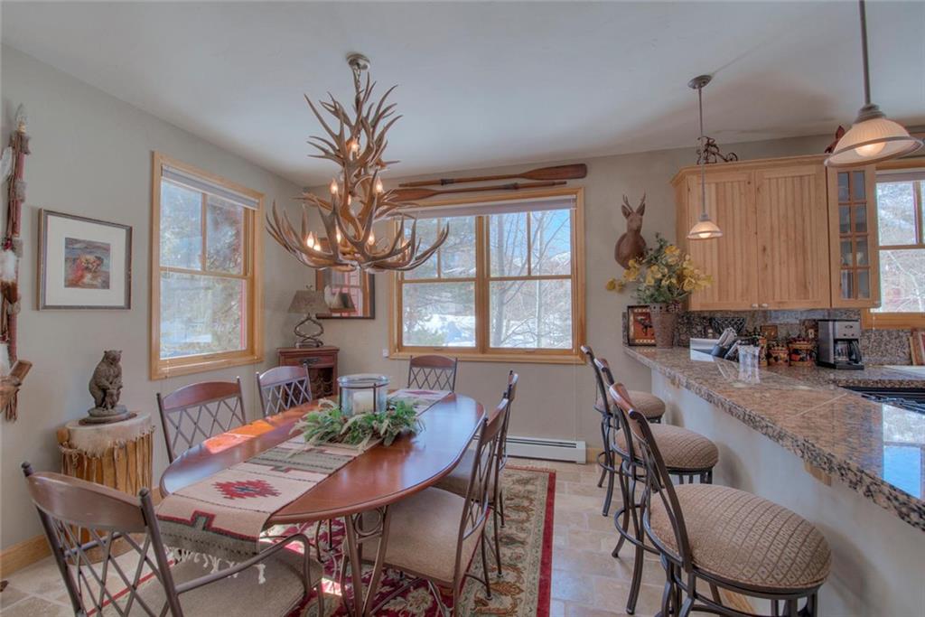 334 D Streamside Lane Frisco, CO 80443 - Photo 7 of 35 a view of a dining room with furniture window and wooden floor