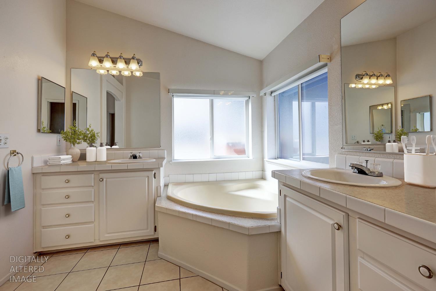 450 Gladycon Road, Unit 83 Colfax, CA 95713 - Photo 15 of 52 a bathroom with a sink vanity granite tub and a mirror