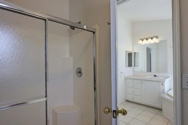 a view of a kitchen with white cabinets