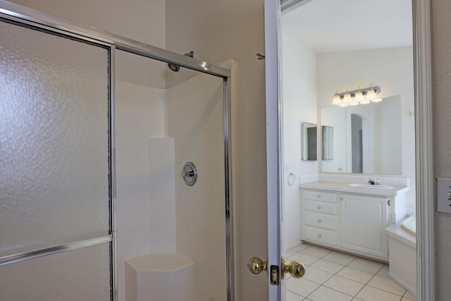 450 Gladycon Road, Unit 83 Colfax, CA 95713 - Photo 16 of 52 a bathroom with a double vanity sink a mirror a shower and vanity