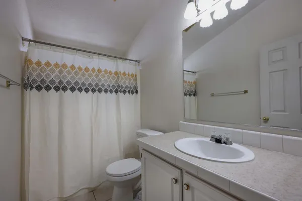 a living room with furniture a flat screen tv and a wooden floor