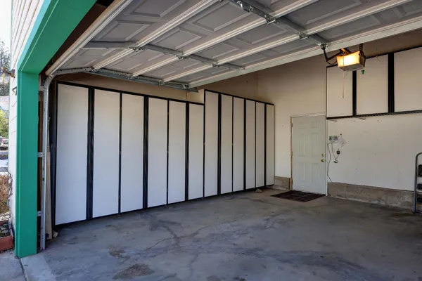 a kitchen with white cabinets and white appliances