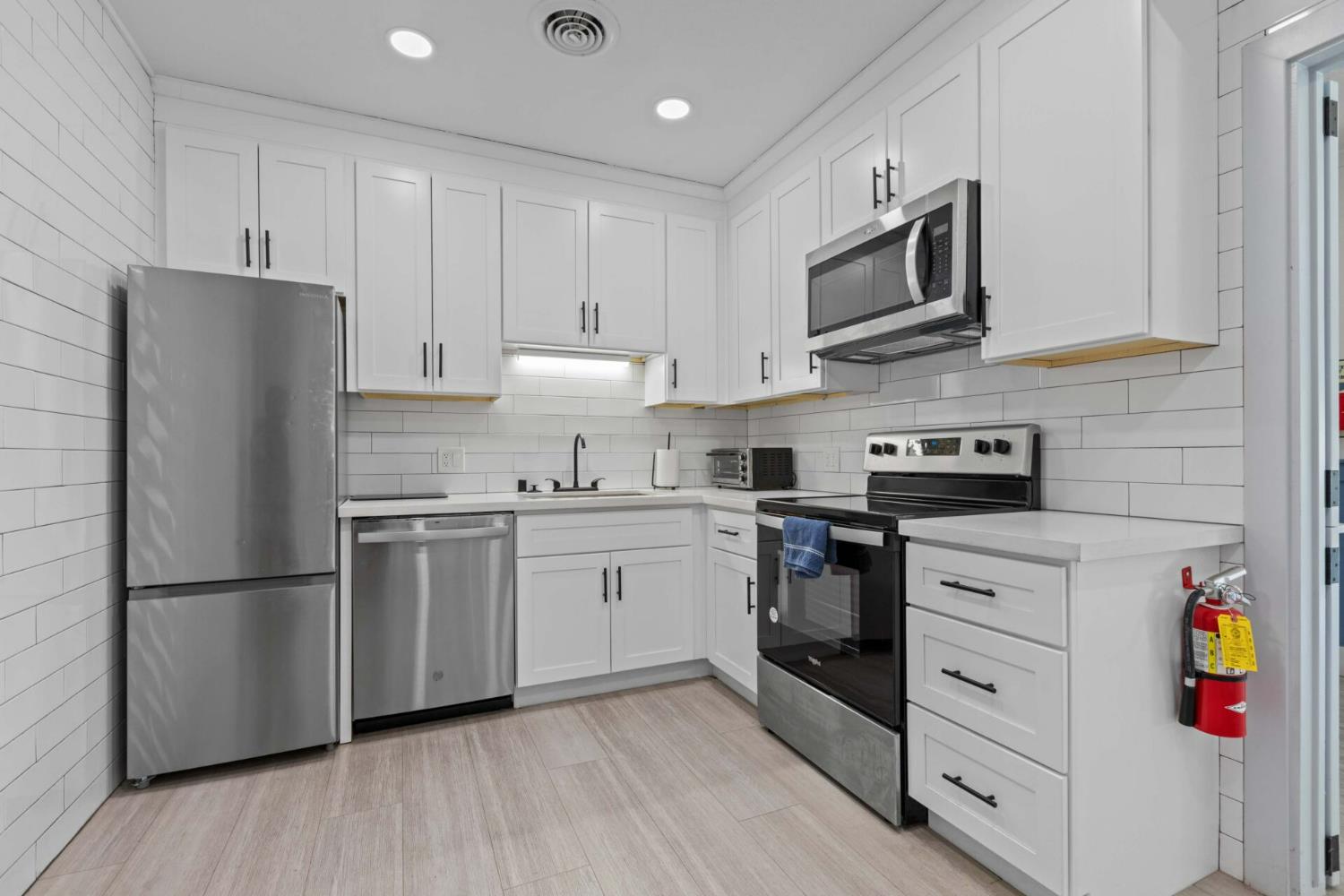 450 Gladycon Road, Unit 83 Colfax, CA 95713 - Photo 32 of 52 a kitchen with stainless steel appliances granite countertop a refrigerator stove a sink and white cabinets