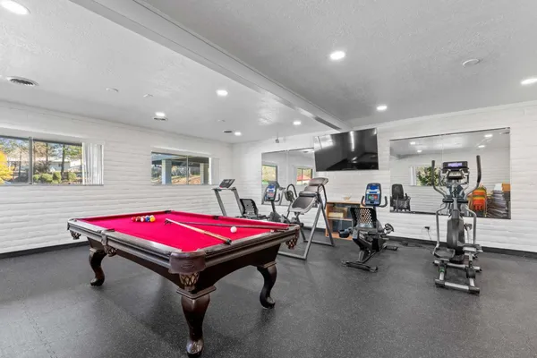 a kitchen with stainless steel appliances granite countertop a stove and a refrigerator