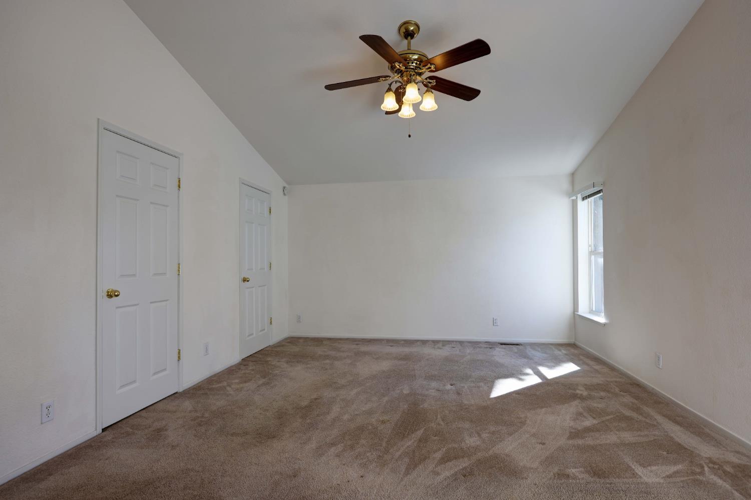 450 Gladycon Road, Unit 83 Colfax, CA 95713 - Photo 40 of 52 an empty room with a chandelier fan and windows