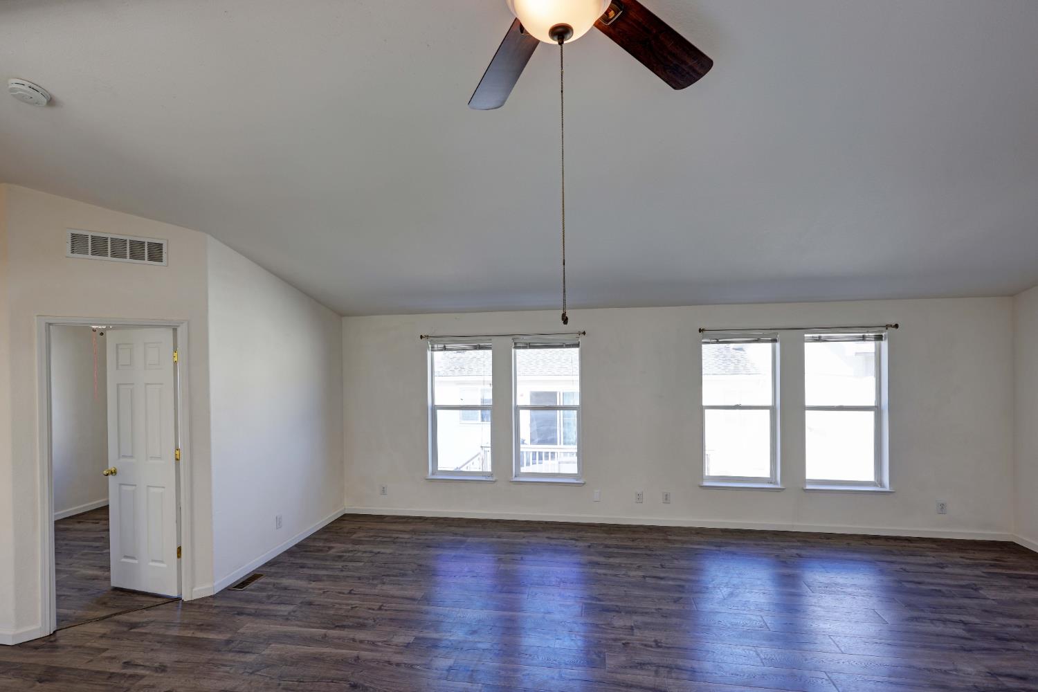 450 Gladycon Road, Unit 83 Colfax, CA 95713 - Photo 46 of 52 an empty room with wooden floor fan and windows