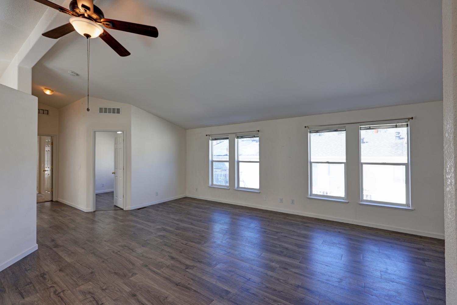 450 Gladycon Road, Unit 83 Colfax, CA 95713 - Photo 5 of 52 an empty room with wooden floor fan and windows