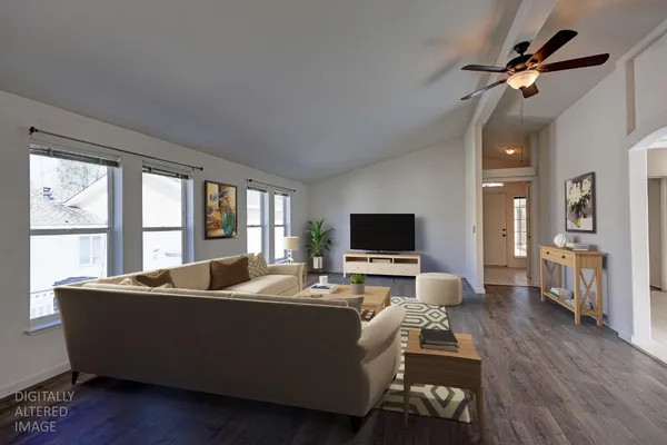 a kitchen with stainless steel appliances a sink a stove and white cabinets