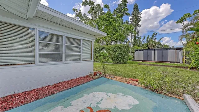 a view of house with backyard space and garden