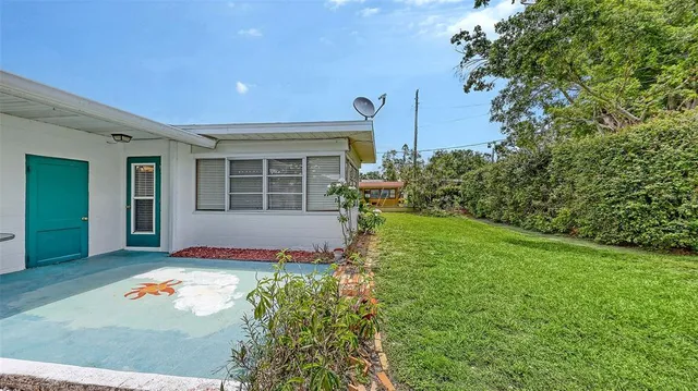 a view of a house with backyard sitting area and garden