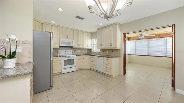 a kitchen with stainless steel appliances granite countertop a refrigerator sink and cabinets
