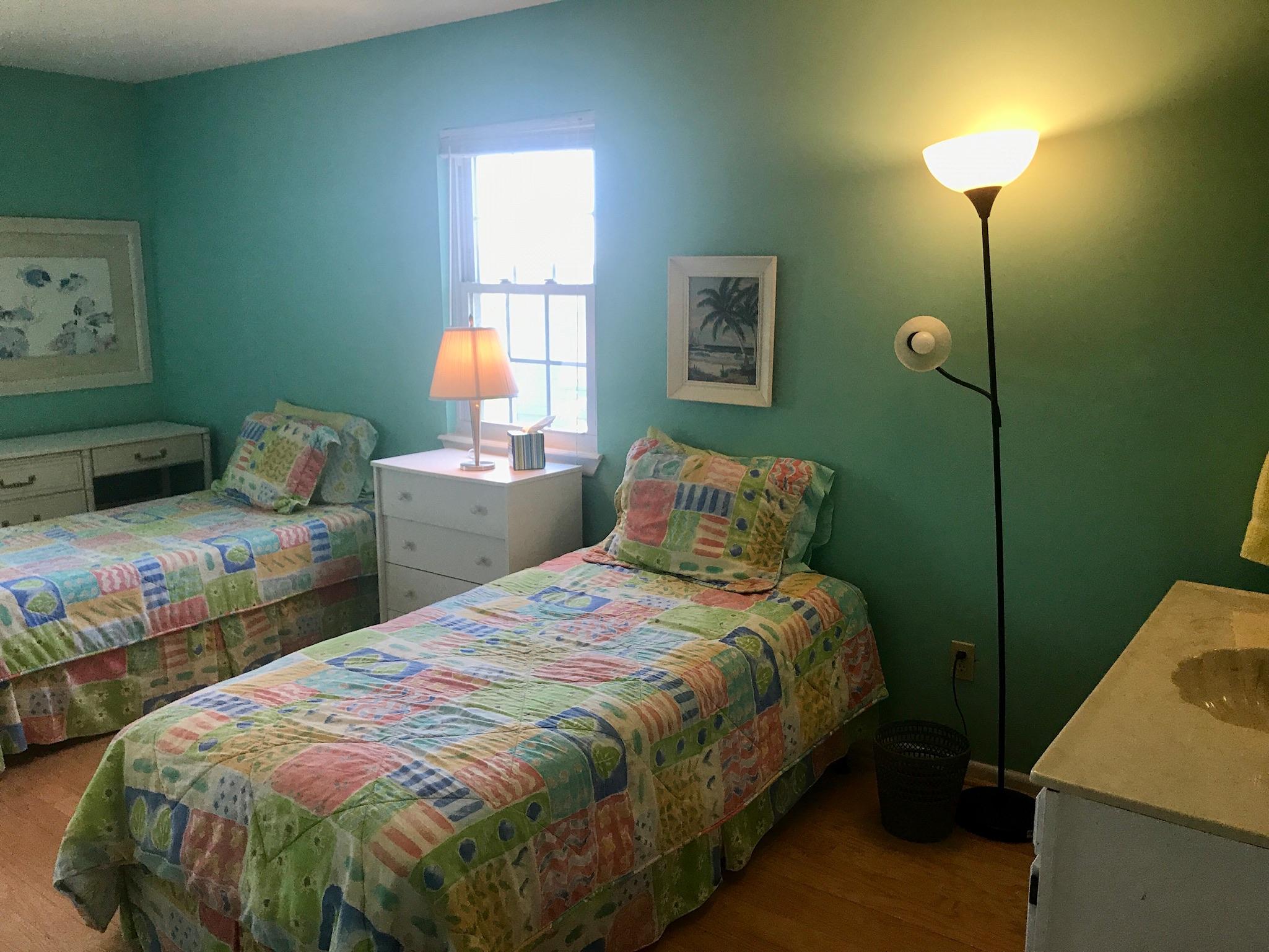71 Baird Road Santa Rosa Beach, FL 32459 - Photo 11 of 16 a bedroom with a bed and a chandelier