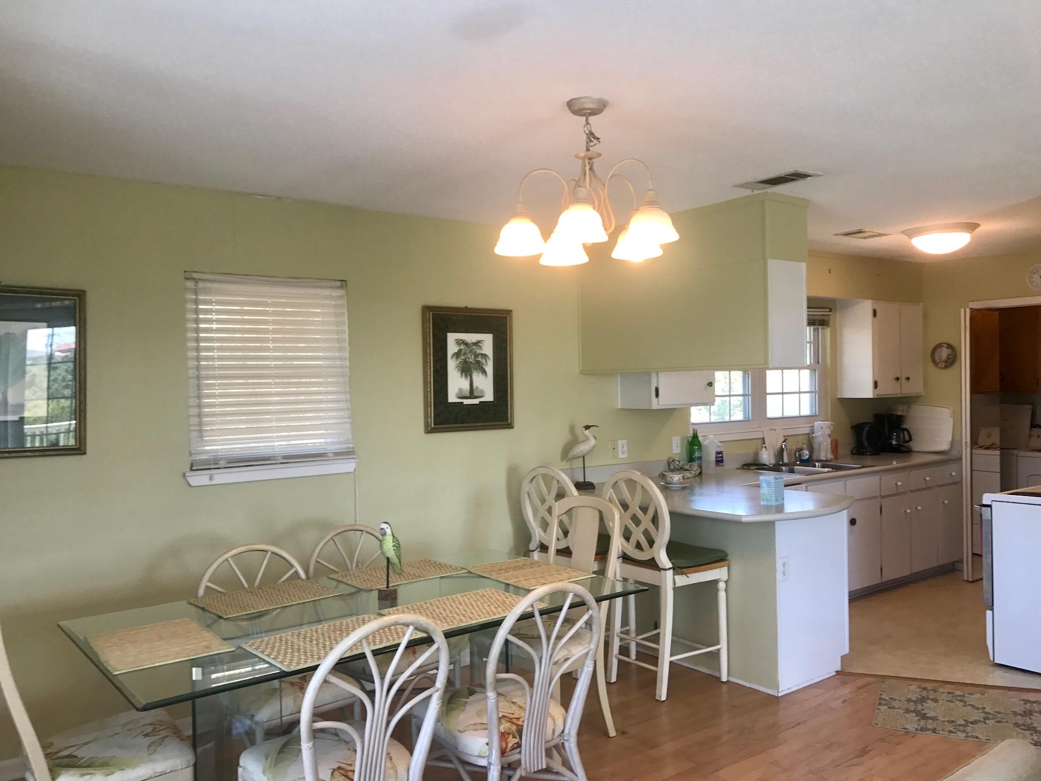 71 Baird Road Santa Rosa Beach, FL 32459 - Photo 7 of 16 a view of a dining room with furniture and chandelier