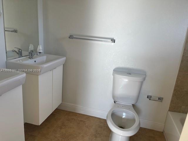 758 Southwest 3rd Place Dania Beach, FL 33004 - Photo 9 of 10 a white toilet sitting next to a bathroom sink