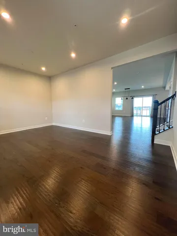 a view of a room with wooden floor