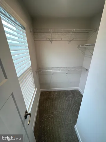 a view of a closet with wooden floor