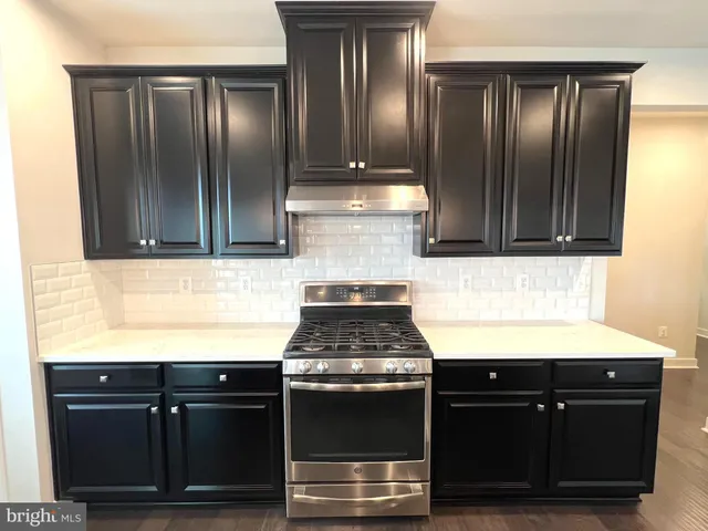 a kitchen with granite countertop stainless steel appliances and cabinets