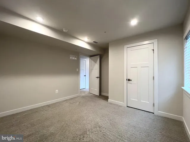 a view of an empty room and a window