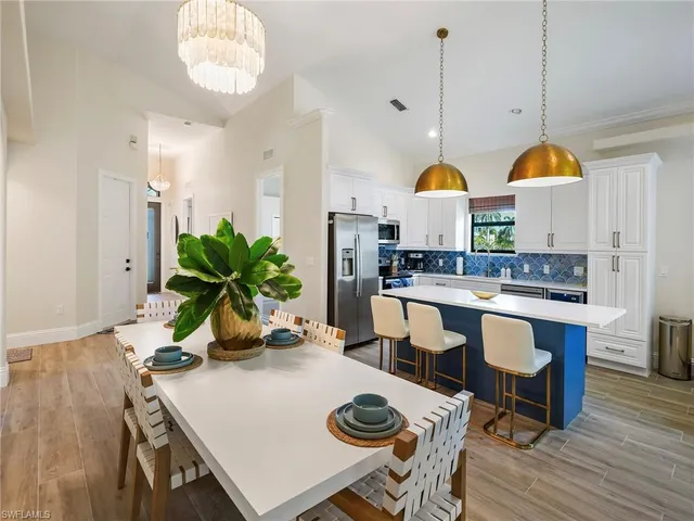 a kitchen with a sink a counter top space stainless steel appliances and cabinets