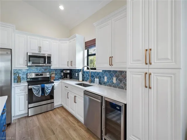 a kitchen with cabinets and chandelier