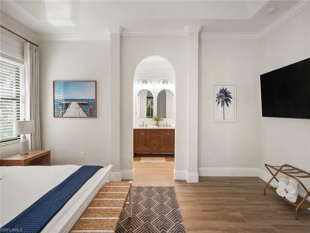 a bathroom with a toilet and a painting on the wall