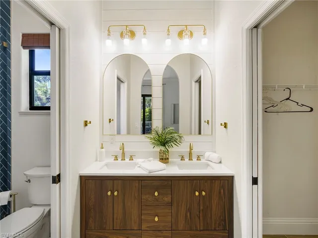 a bathroom with 2 sink and a mirror