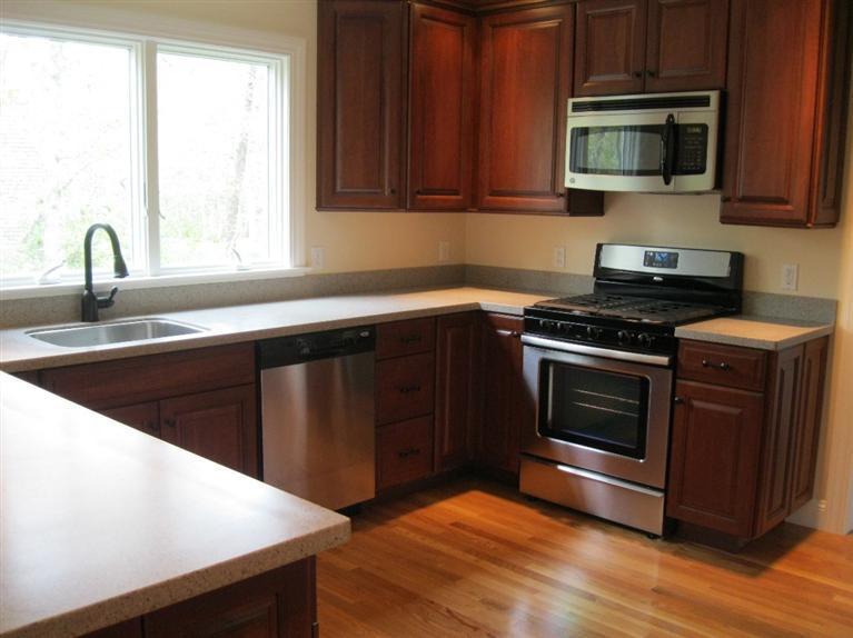 26 Oliver Snow Road Harwich Port, MA 02646 - Photo 8 of 33 a kitchen with a stove and a microwave
