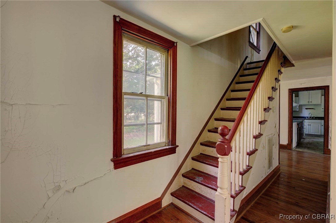 708 Calthrop Neck Road Yorktown, VA 23693 - Photo 13 of 24 Staircase with wood finished floors and baseboards