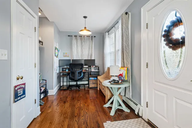a view of a livingroom with furniture wooden floor and a chandelier