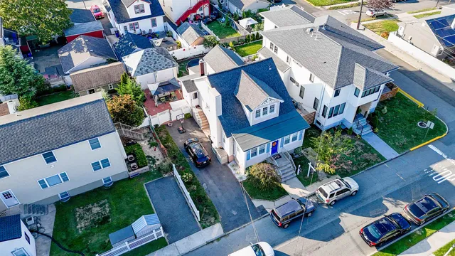 an aerial view of a house with a yard
