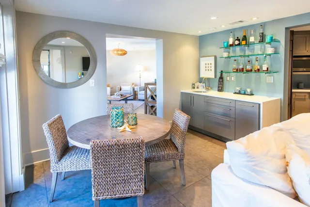 a dining room with furniture a rug and wooden floor