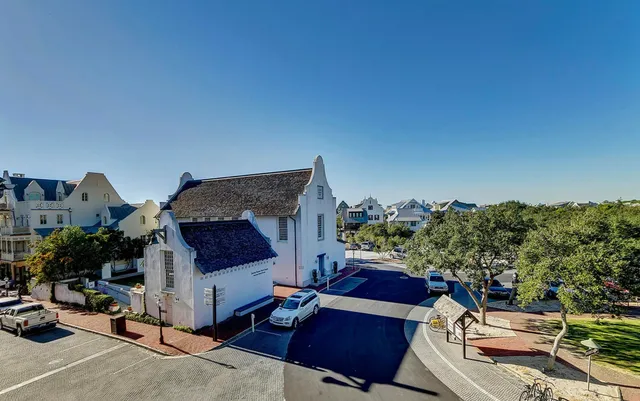a view of a balcony with chairs and potted plants